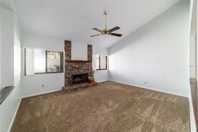 a view of empty room with a fireplace