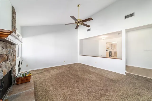 a view of empty room with a fireplace