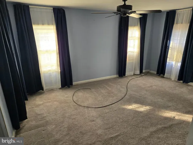 a view of a livingroom with a fireplace and windows