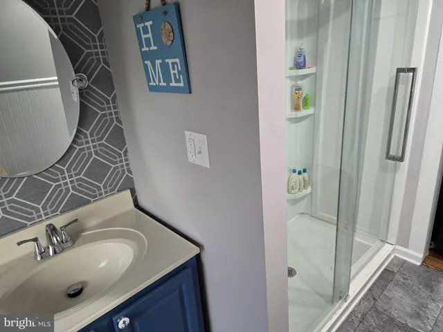 a bathroom with a sink and mirror