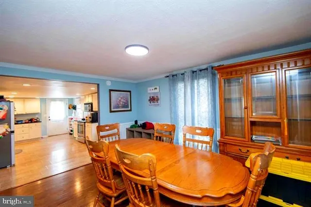 a dining room with furniture and wooden floor