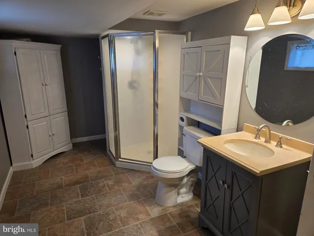 a bathroom with a sink toilet and mirror