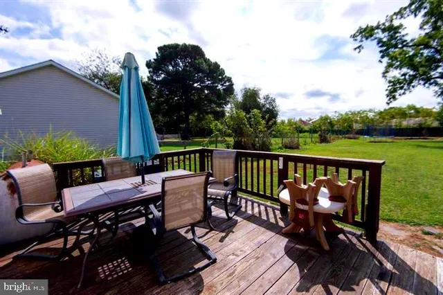 a view of a chairs and table on the roof deck