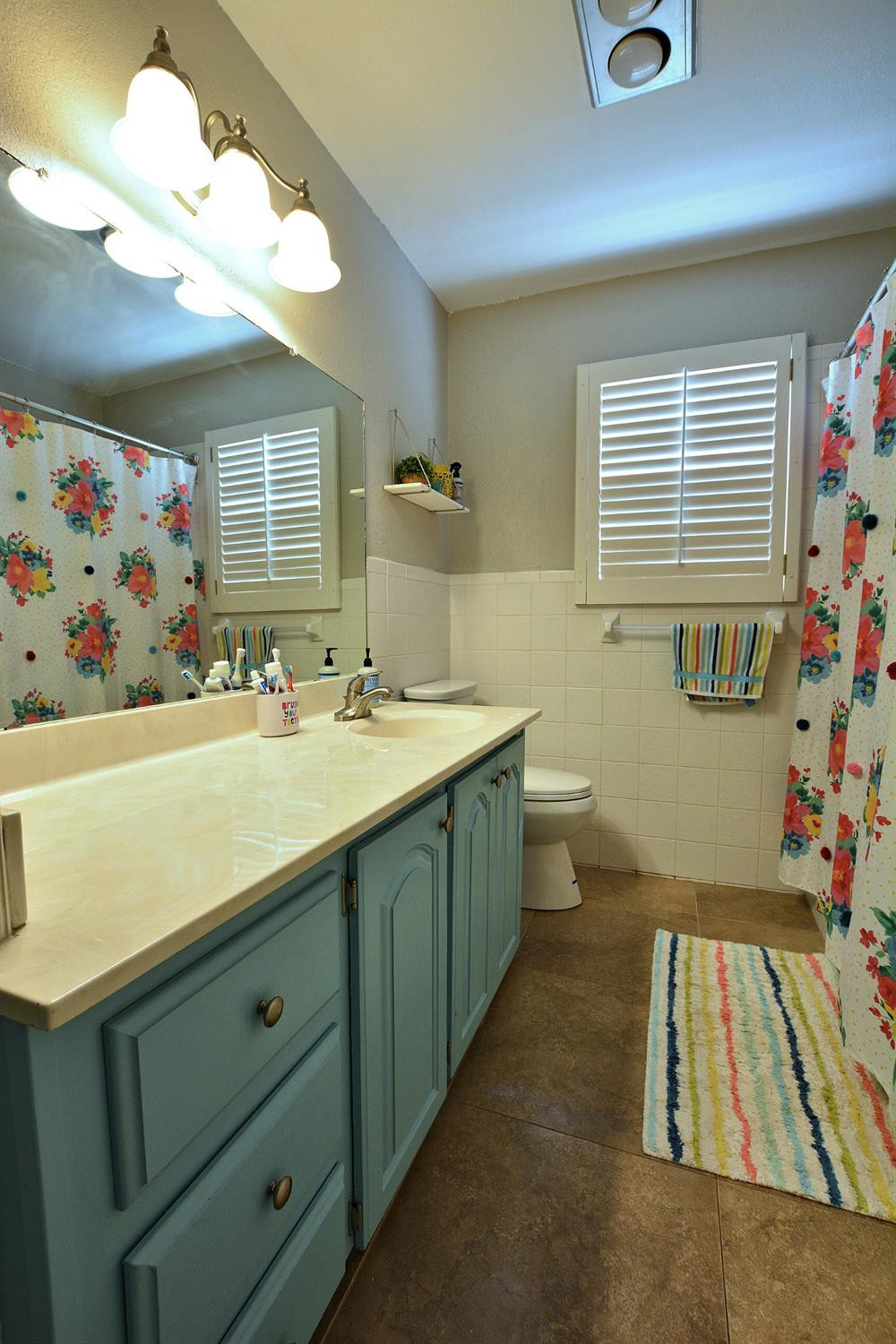 4903 17th Street Lubbock, TX 79416 - Photo 21 of 25 a bathroom with a sink a vanity and a mirror