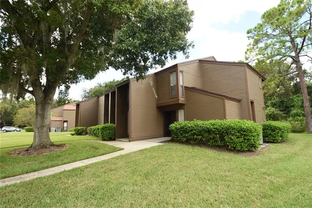 a house that has a tree in front of it