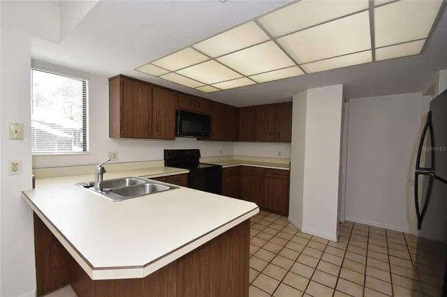 a kitchen with a sink a stove a microwave and cabinets