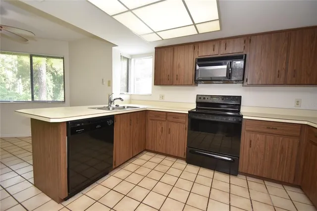 a kitchen with a sink stove and microwave