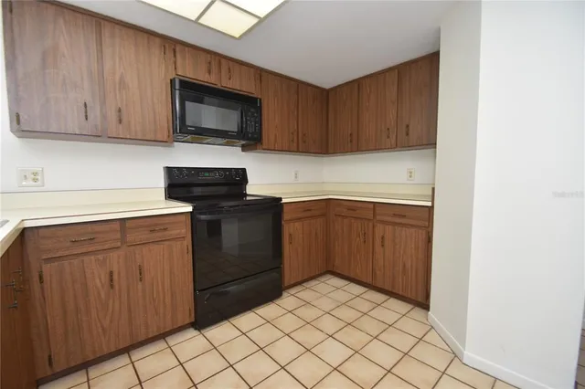 a kitchen with a sink stove and microwave