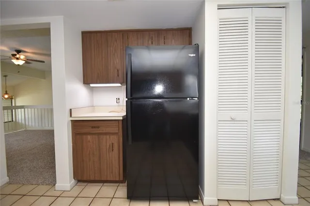 a kitchen with a refrigerator and cabinets