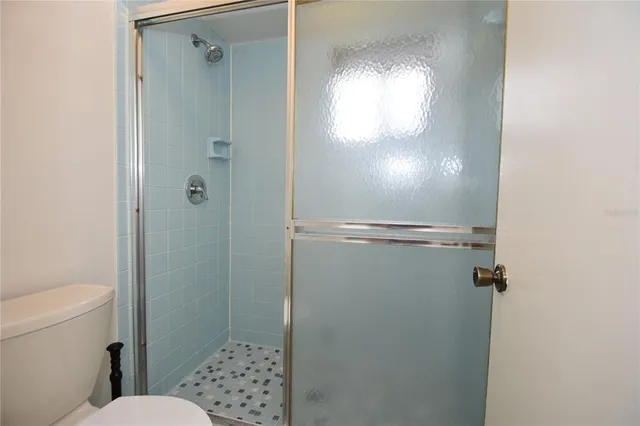 a bathroom with a toilet and a shower