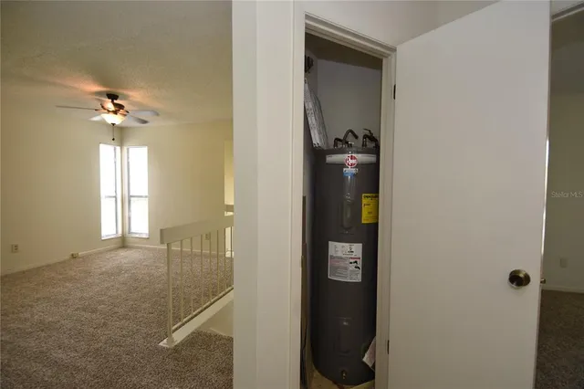 a view of a bathroom from a hallway with wooden floor