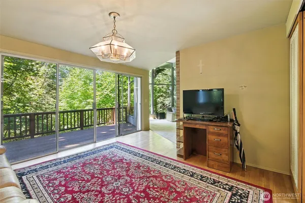 a living room with hardwood floor and a flat screen tv