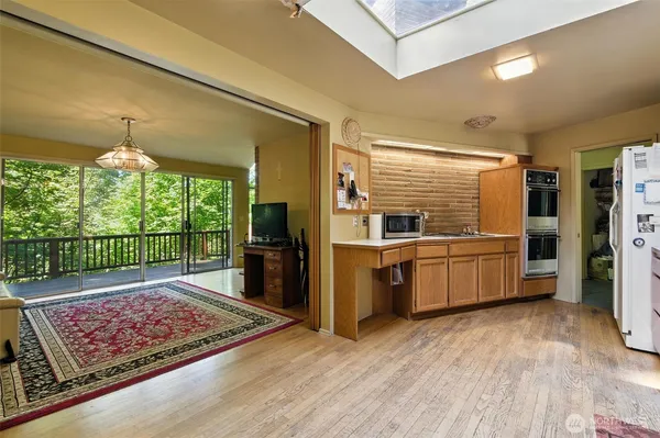 a kitchen with stainless steel appliances granite countertop a refrigerator and a sink