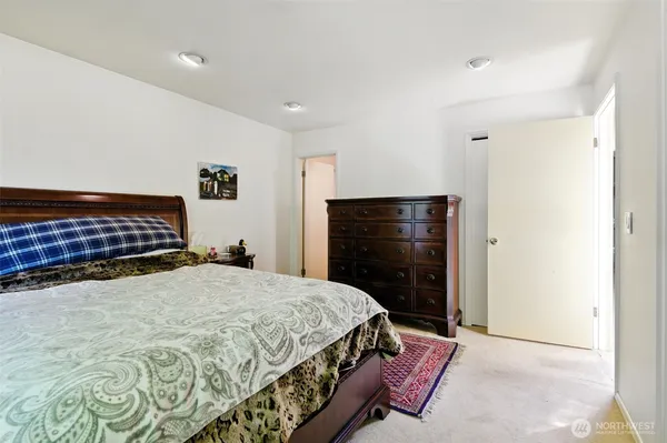 a spacious bathroom with a granite countertop sink a toilet and a mirror