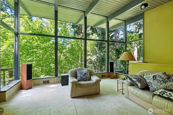 a bedroom with furniture and a large window