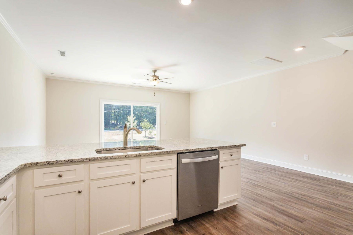 6932 Outfall Point Lane Raleigh, NC 27616 - Photo 3 of 14 a kitchen with granite countertop white cabinets and white appliances
