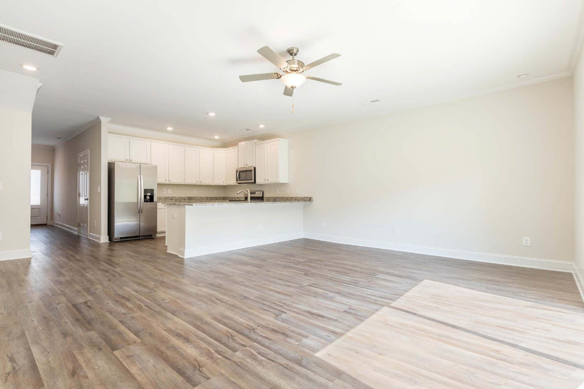 6932 Outfall Point Lane Raleigh, NC 27616 - Photo 8 of 14 a view of a kitchen with a sink and a refrigerator