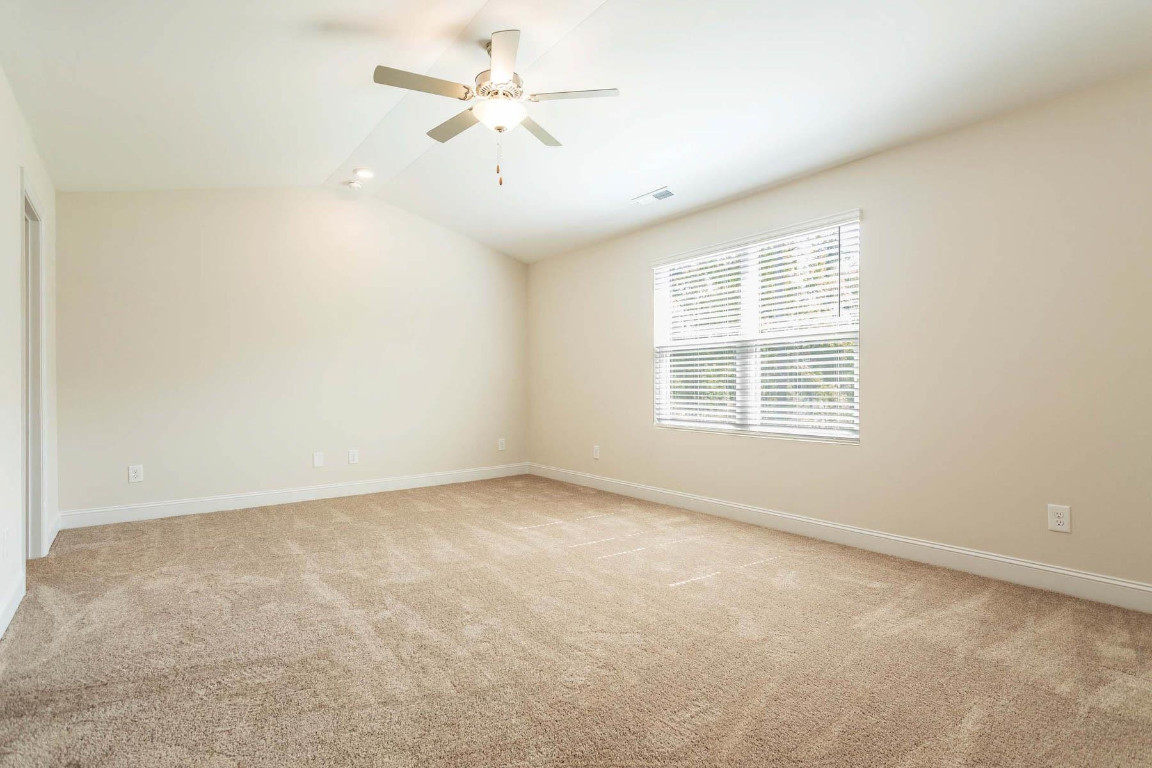 6932 Outfall Point Lane Raleigh, NC 27616 - Photo 10 of 14 an empty room with a window and a ceiling fan
