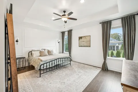 a spacious bedroom with a bed and a window