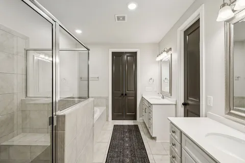 a bathroom with a sink a toilet and a shower