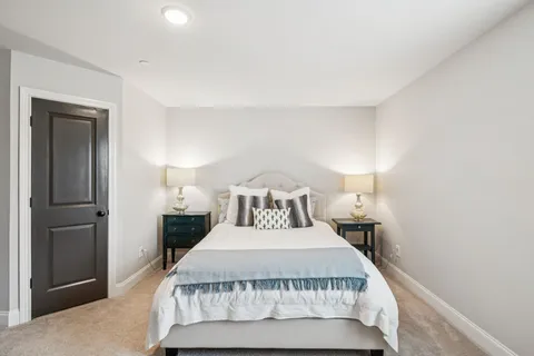 a bedroom with a bed and a night stand