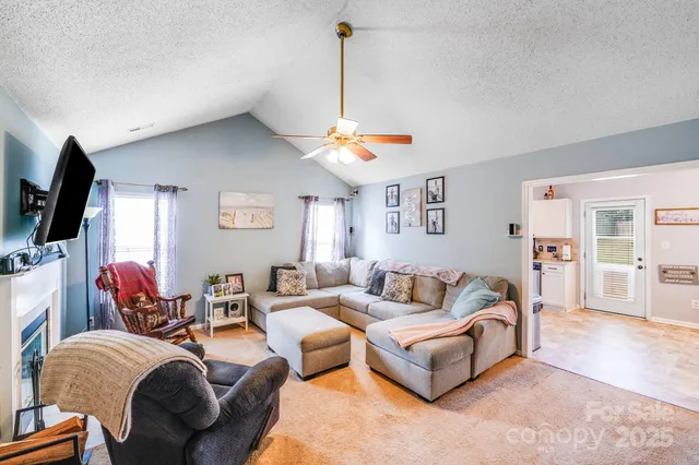a living room with furniture a flat screen tv and a window