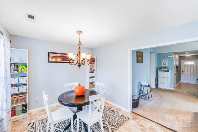 a room with furniture a rug and a chandelier