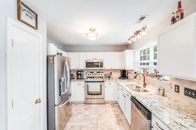 a kitchen with a sink stove and refrigerator