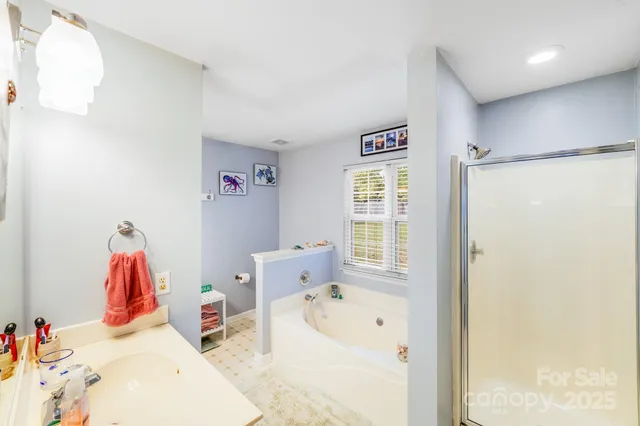 a en suite bathroom with a tub and a window