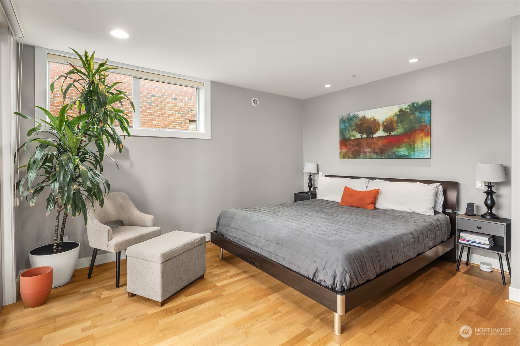 315 West Galer Street, Unit 101 Seattle, WA 98119 - Photo 13 of 37 a bedroom with a bed and a potted plant