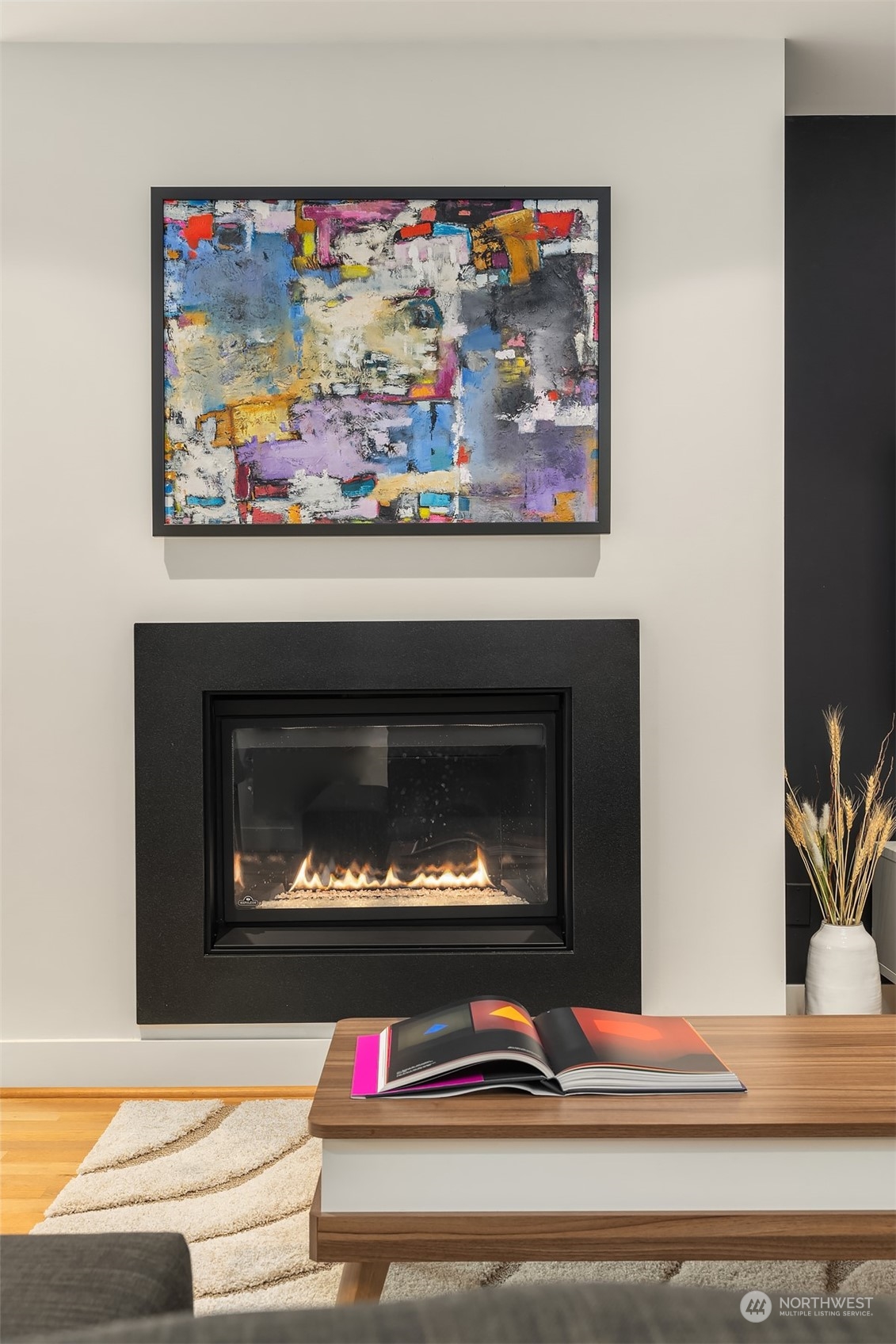 315 West Galer Street, Unit 101 Seattle, WA 98119 - Photo 4 of 37 a living room with a fireplace and wall paintings