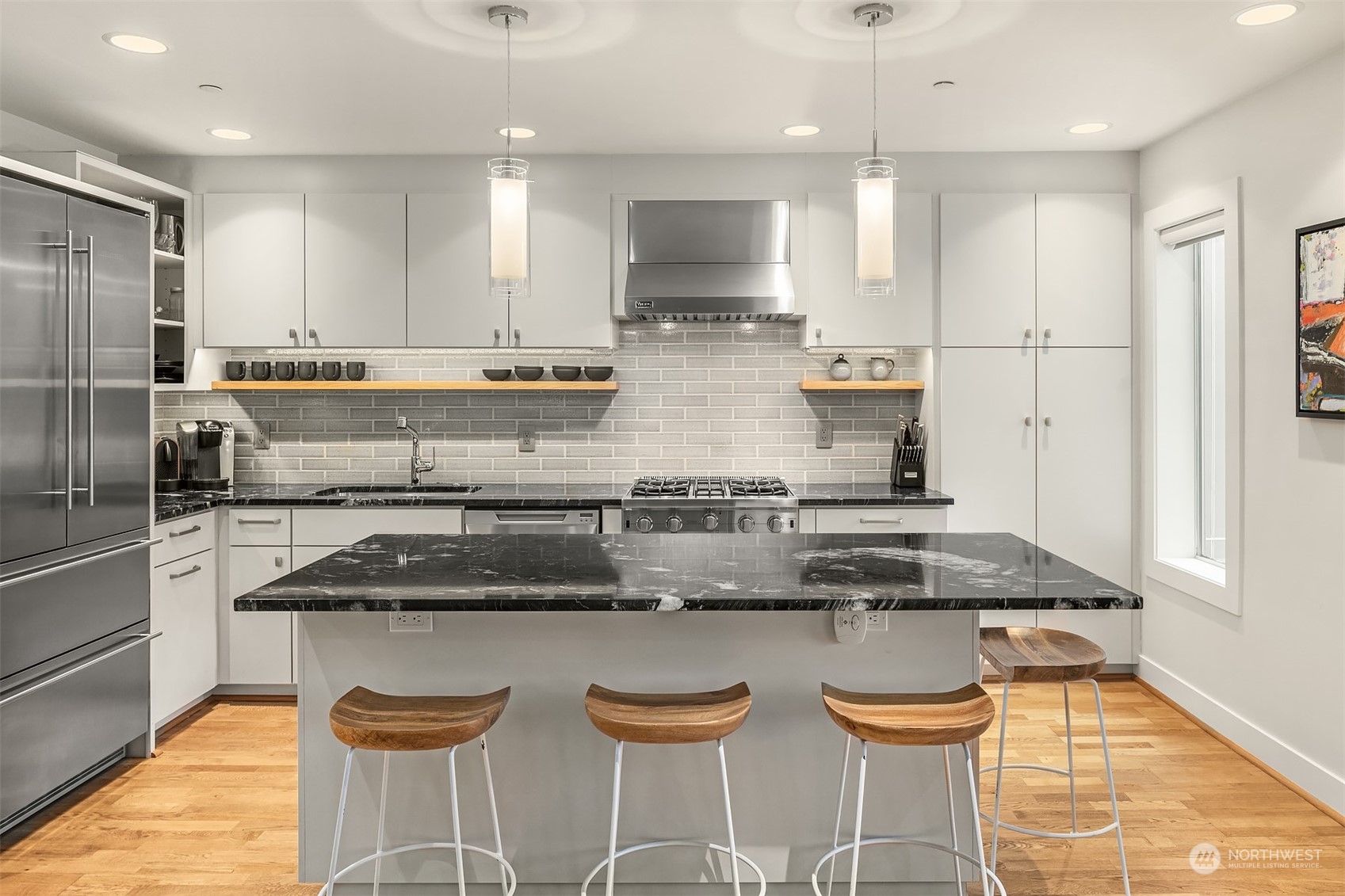 315 West Galer Street, Unit 101 Seattle, WA 98119 - Photo 7 of 37 a kitchen with stainless steel appliances granite countertop a sink and a refrigerator