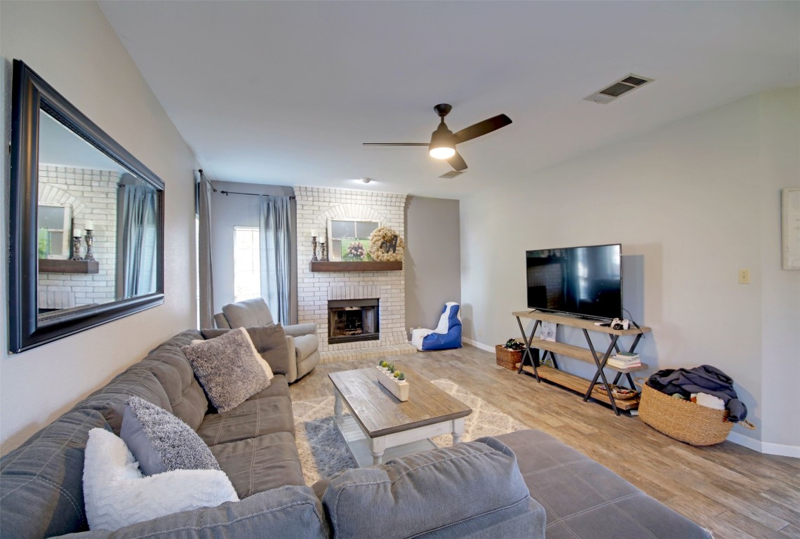 917 Forest Trail Cedar Park, TX 78613 - Photo 1 of 1 a living room with furniture and a flat screen tv with wooden floor