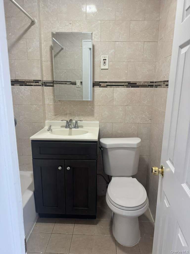 88-54 75th Street Queens, NY 11421 - Photo 13 of 14 a bathroom with a sink and a toilet
