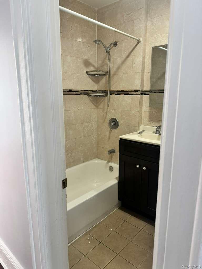 88-54 75th Street Queens, NY 11421 - Photo 14 of 14 a bathroom with a bathtub and a shower