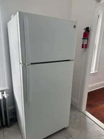 a white refrigerator freezer and a refrigerator in a kitchen
