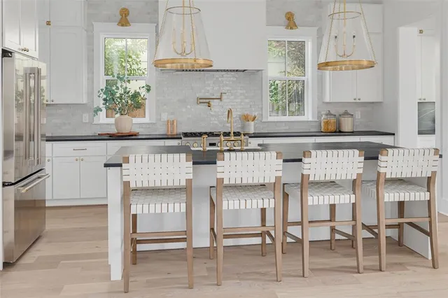 a kitchen with granite countertop a stove a sink and a granite counter tops