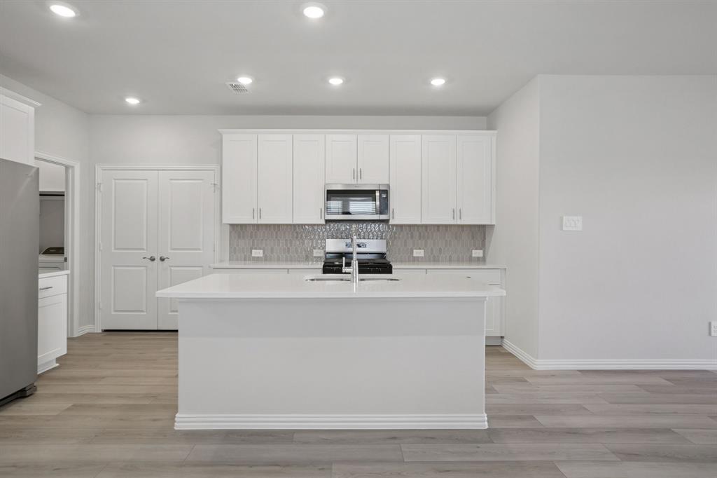 809 River Lane Lavon, TX 75166 - Photo 15 of 39 a view of kitchen with stainless steel appliances granite countertop a stove a sink and a refrigerator