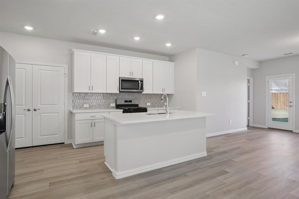 809 River Lane Lavon, TX 75166 - Photo 16 of 39 a white kitchen with wooden floor