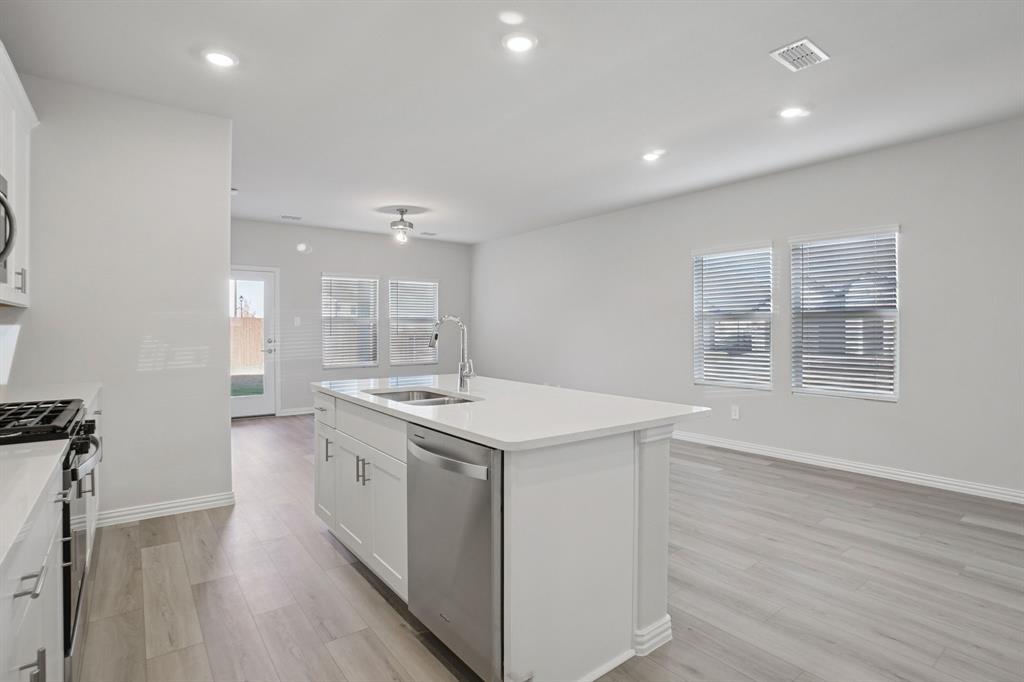 809 River Lane Lavon, TX 75166 - Photo 17 of 39 a kitchen with a sink and wooden floor