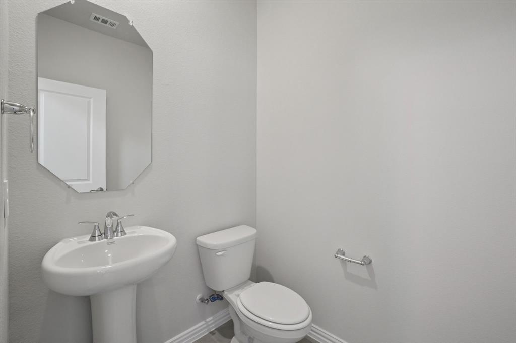 809 River Lane Lavon, TX 75166 - Photo 19 of 39 a bathroom with a sink a toilet and mirror