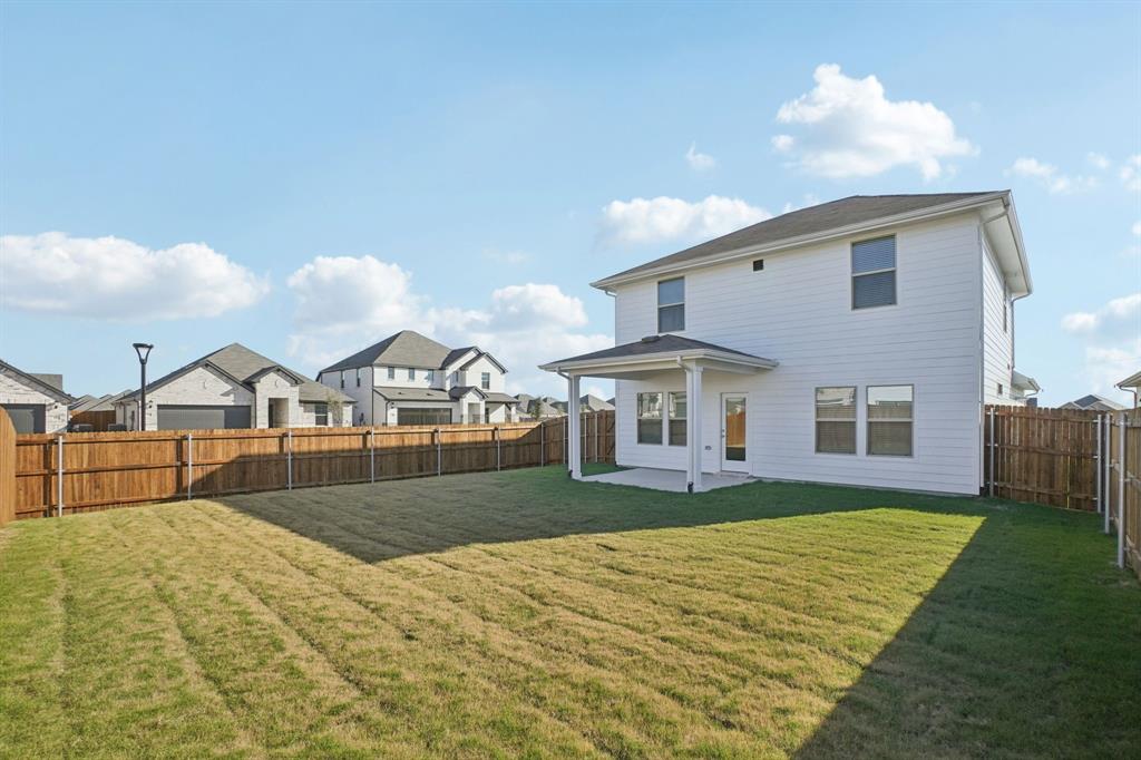809 River Lane Lavon, TX 75166 - Photo 36 of 39 a front view of a house with a yard and garage
