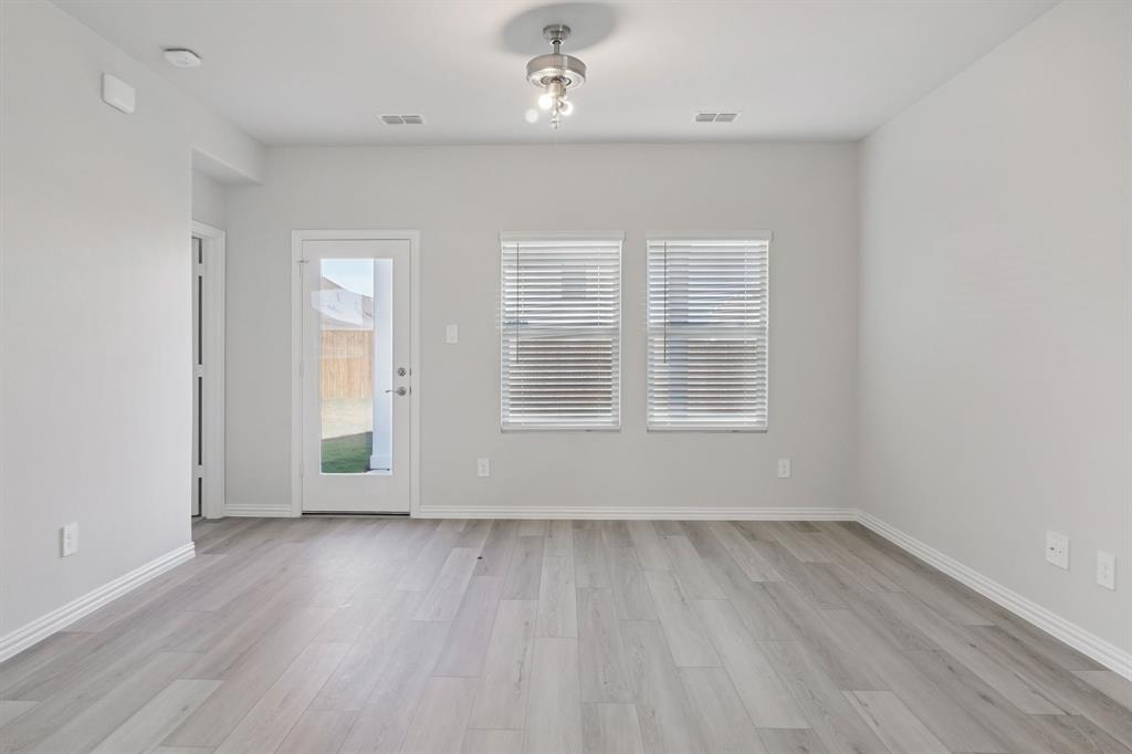 809 River Lane Lavon, TX 75166 - Photo 7 of 39 an empty room with wooden floor and windows