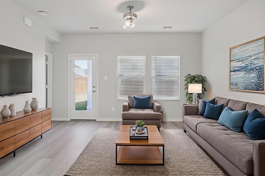 809 River Lane Lavon, TX 75166 - Photo 8 of 39 a living room with furniture and a flat screen tv