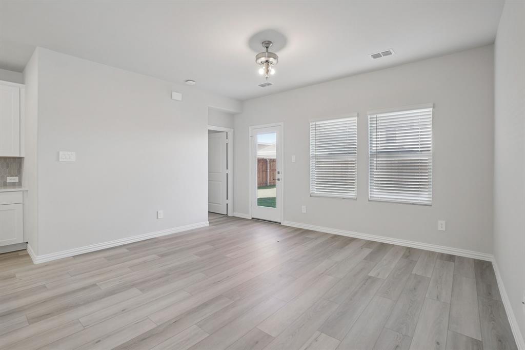 809 River Lane Lavon, TX 75166 - Photo 9 of 39 a view of an empty room with wooden floor and a window