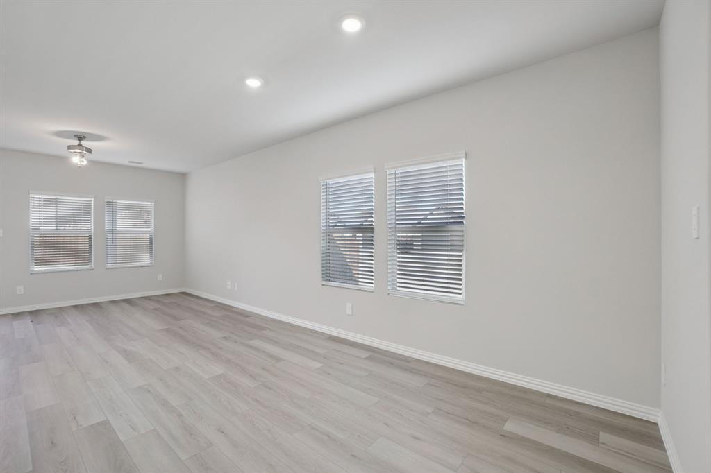 809 River Lane Lavon, TX 75166 - Photo 10 of 39 a view of an empty room with wooden floor and a window