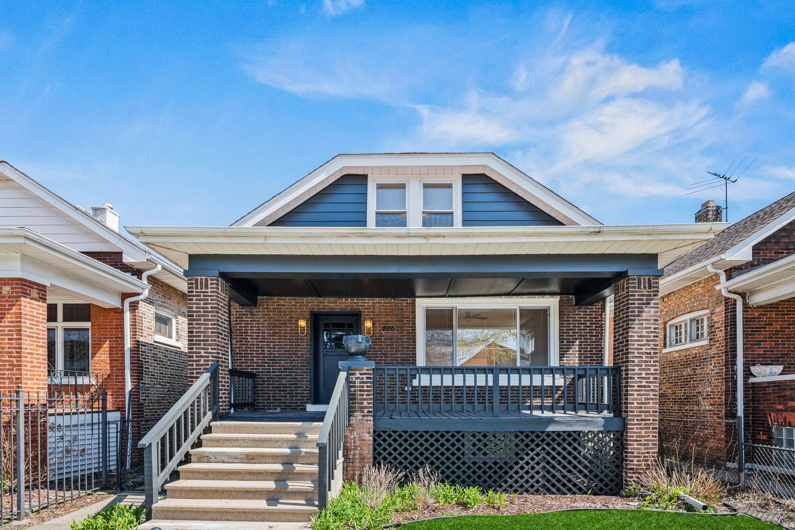 7955 South Colfax Avenue Chicago, IL 60617 - Photo 1 of 24 a front view of a house with a garden
