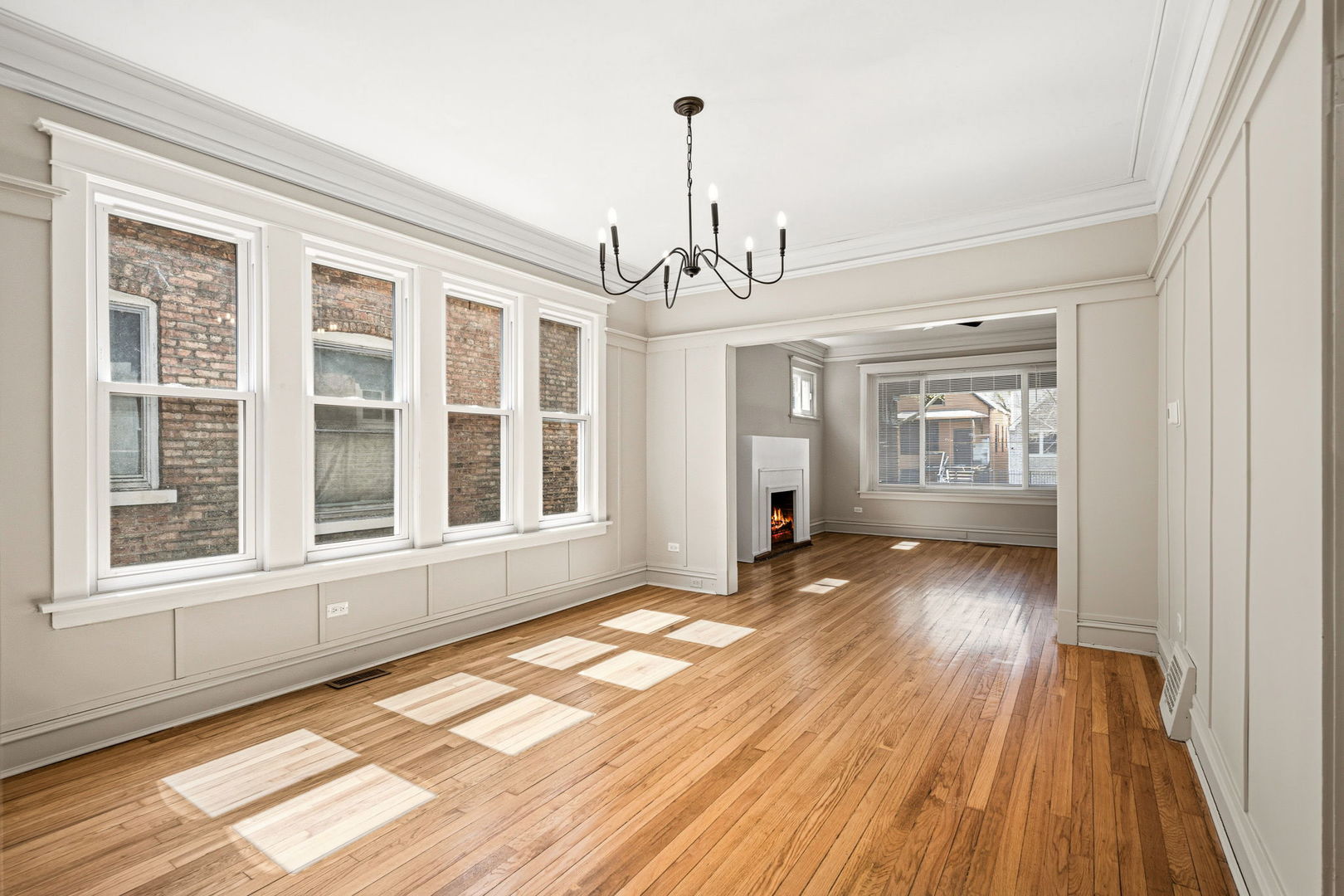 7955 South Colfax Avenue Chicago, IL 60617 - Photo 6 of 24 a view of a room with wooden floor and windows