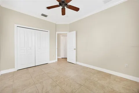 a view of a livingroom with a ceiling fan and window