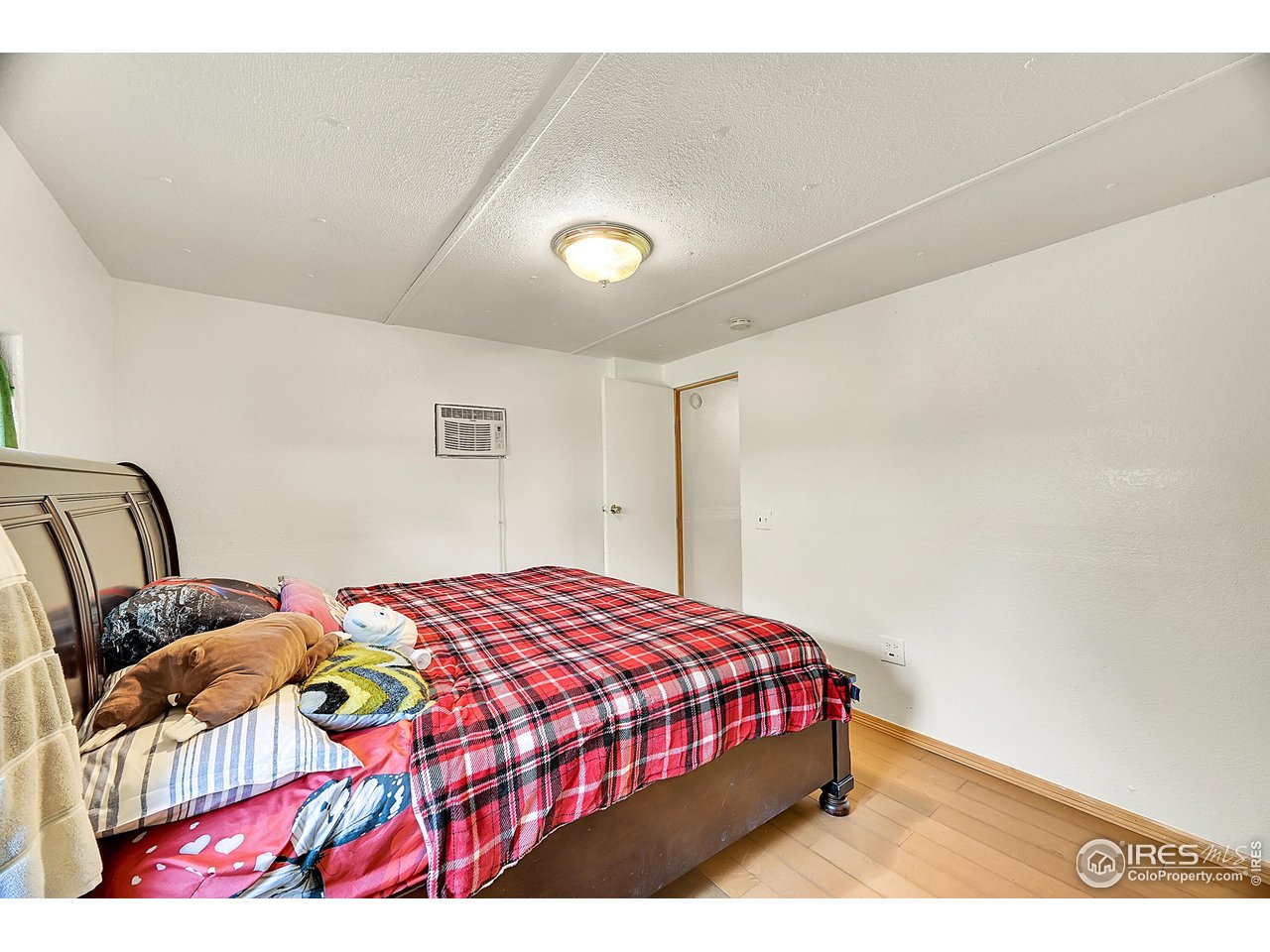2500 East Harmony Road, Unit 178 Fort Collins, CO 80528 - Photo 21 of 22 a bedroom with a bed and a painting on the wall